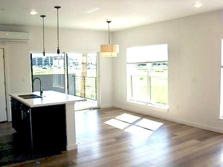 kitchen featuring a sink, plenty of natural light, wood finished floors, and recessed lighting