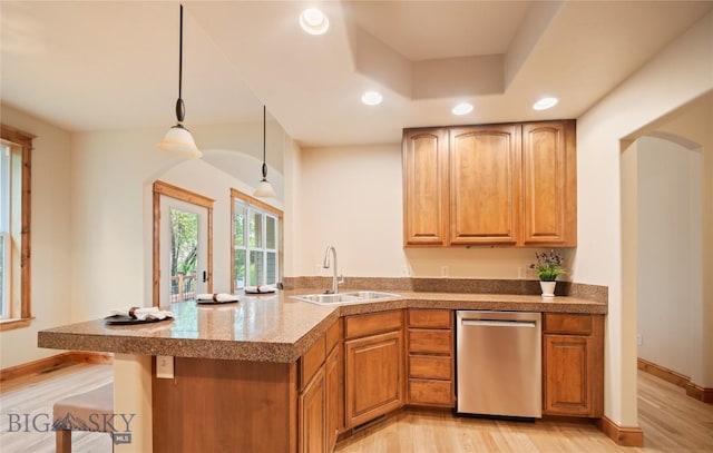 1004 Oconnell Dr, Bozeman, MT 59715 - kitchen with stainless steel dishwasher, a sink, recessed lighting, arched walkways, and a peninsula