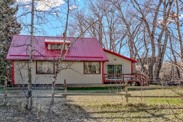 185 Elk Creek Rd N, Wilsall, MT 59086 - view of front of property with metal roof, fence, and a wooden deck