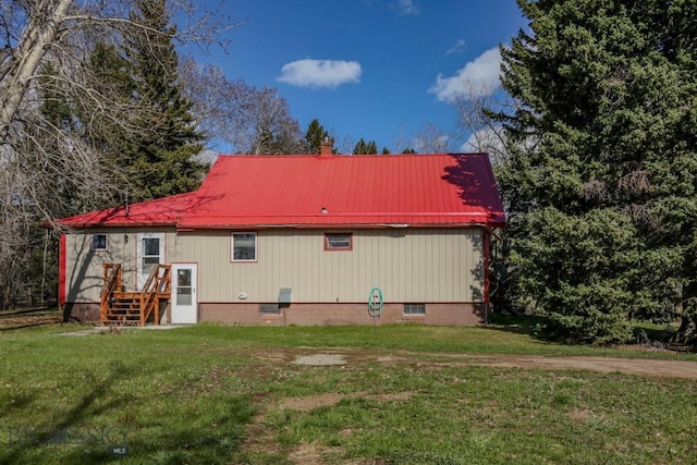 185 Elk Creek Rd N, Wilsall, MT 59086 - back of house featuring a lawn, metal roof, crawl space, and a chimney