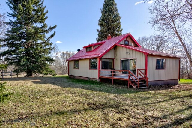 185 Elk Creek Rd N, Wilsall, MT 59086 - back of house with a deck, metal roof, and a lawn