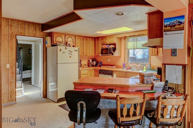 185 Elk Creek Rd N, Wilsall, MT 59086 - kitchen with freestanding refrigerator, dishwashing machine, light countertops, stainless steel microwave, and wooden walls