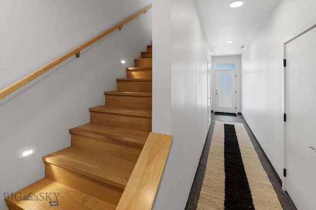 staircase featuring inlaid floor details and recessed lighting