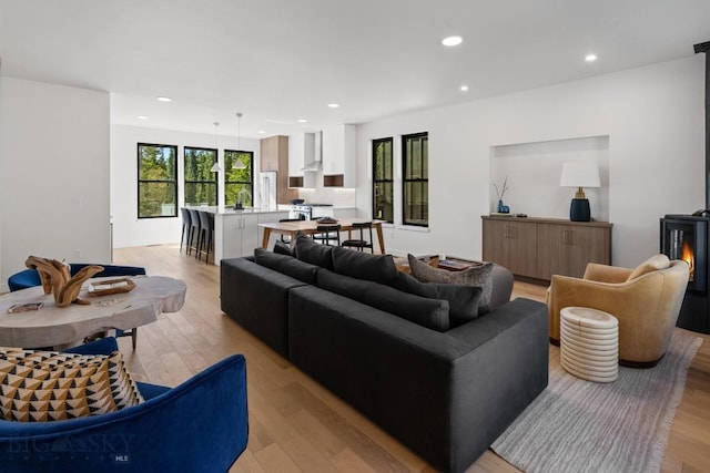 living room with recessed lighting and light wood finished floors