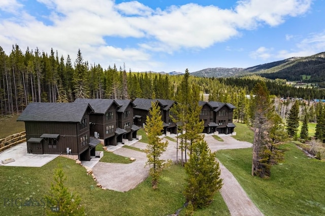 view from above of property with a heavily wooded area and mountains