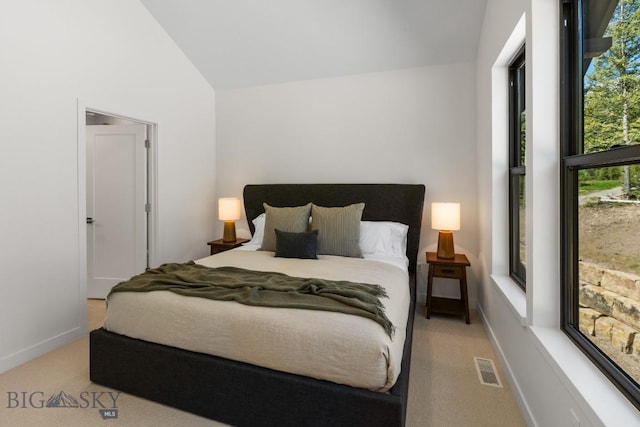 bedroom with light carpet, baseboards, and high vaulted ceiling
