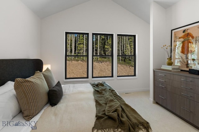 bedroom with lofted ceiling, light colored carpet, and baseboards