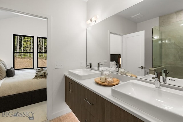 full bathroom with connected bathroom, a tile shower, and double vanity