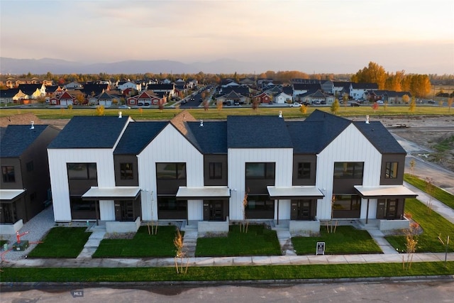 3030 Autumn Grove St Unit C, Bozeman, MT 59718 - modern inspired farmhouse featuring a residential view, a shingled roof, and a yard