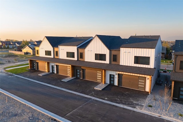 3030 Autumn Grove St Unit C, Bozeman, MT 59718 - view of front facade featuring board and batten siding, a garage, asphalt driveway, and a residential view