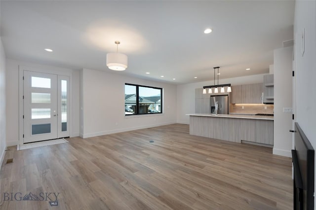 3030 Autumn Grove St Unit C, Bozeman, MT 59718 - unfurnished living room featuring light wood-style floors, recessed lighting, and baseboards