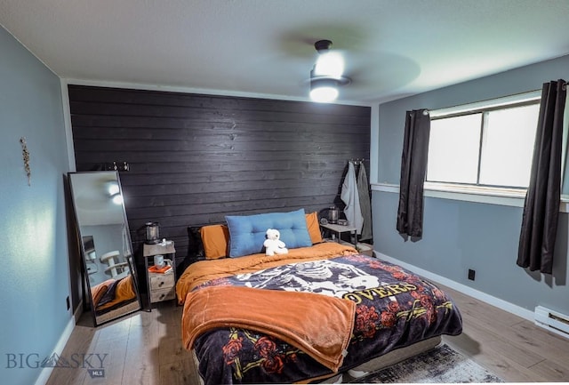 902 E Gallatin Ave, Belgrade, MT 59714 - bedroom featuring wood finished floors, baseboards, a baseboard radiator, and a ceiling fan