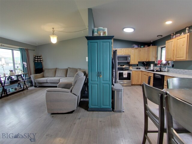902 E Gallatin Ave, Belgrade, MT 59714 - kitchen featuring stainless steel appliances, light brown cabinetry, open floor plan, light countertops, and healthy amount of natural light