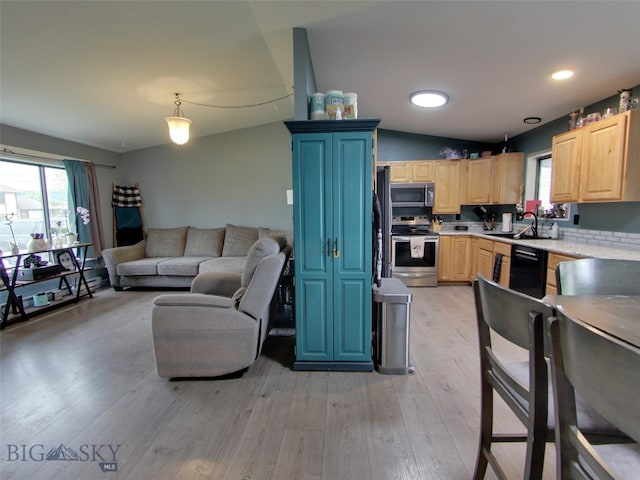 902 E Gallatin Ave, Belgrade, MT 59714 - kitchen featuring stainless steel appliances, light brown cabinetry, open floor plan, light countertops, and healthy amount of natural light