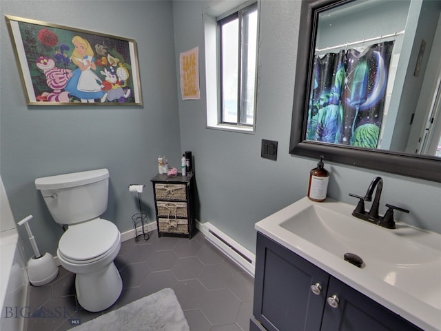 902 E Gallatin Ave, Belgrade, MT 59714 - full bath with a baseboard radiator, toilet, vanity, tile patterned flooring, and baseboards