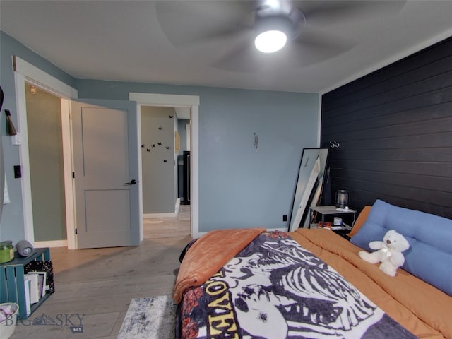 902 E Gallatin Ave, Belgrade, MT 59714 - bedroom featuring wood finished floors, wood walls, and ceiling fan