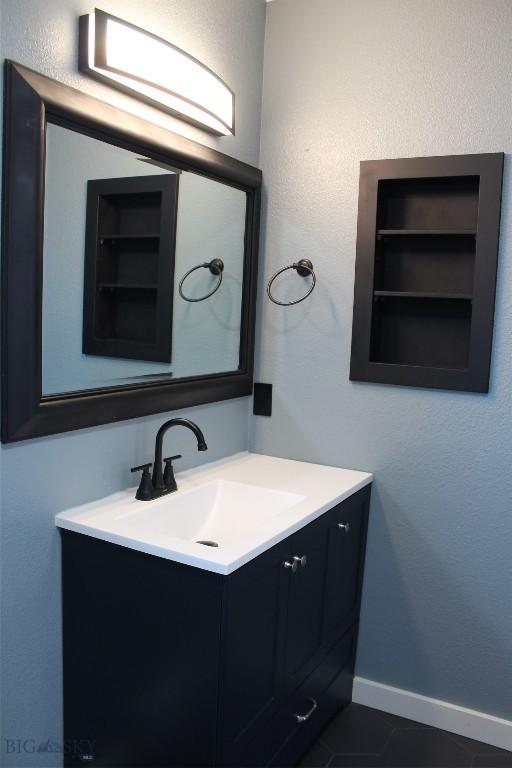902 E Gallatin Ave, Belgrade, MT 59714 - bathroom with vanity and baseboards