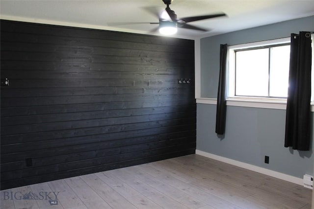 902 E Gallatin Ave, Belgrade, MT 59714 - empty room with ceiling fan, light wood finished floors, and wooden walls