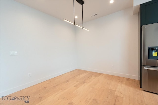 unfurnished dining area with light wood-style floors, baseboards, and recessed lighting