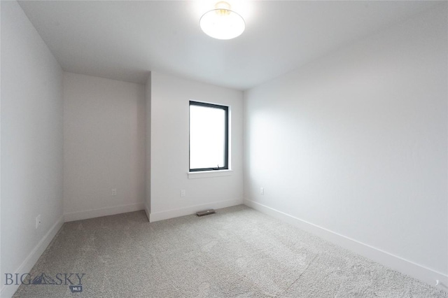 carpeted spare room with baseboards