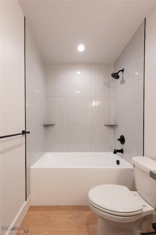 full bath featuring toilet, wood finished floors, bathing tub / shower combination, and recessed lighting