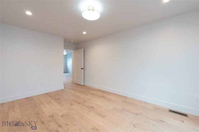 spare room featuring baseboards, light wood-style flooring, and recessed lighting