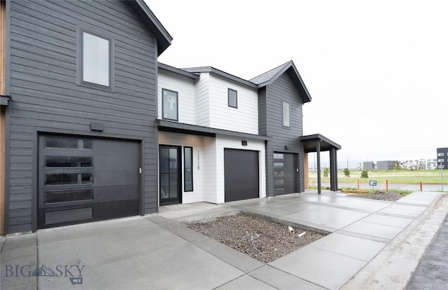 contemporary home with driveway and an attached garage