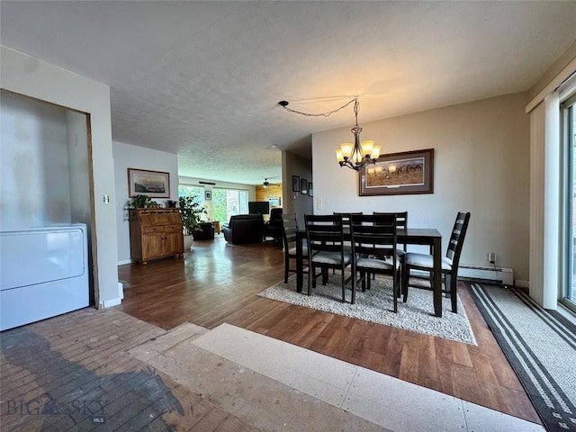 205 E Chinook St, Livingston, MT 59047 - dining room with a chandelier, dark wood-style floors, and baseboards