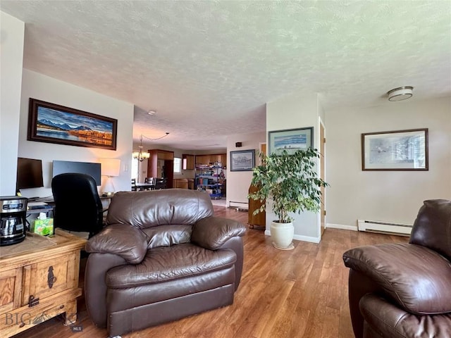 205 E Chinook St, Livingston, MT 59047 - living area with a baseboard radiator, wood finished floors, a textured ceiling, baseboards, and baseboard heating