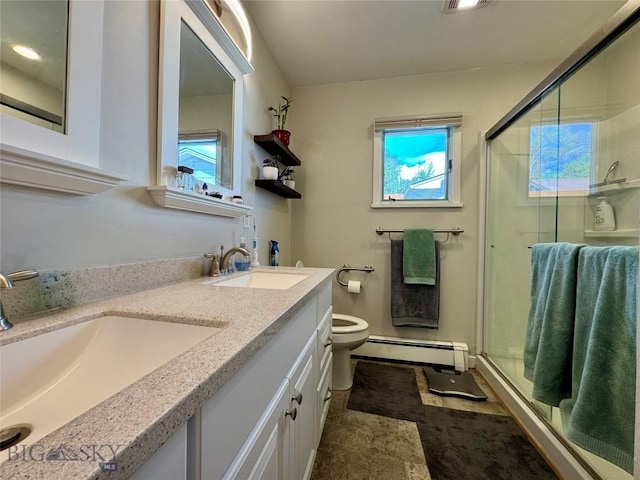 205 E Chinook St, Livingston, MT 59047 - full bath featuring baseboard heating, a stall shower, toilet, and double vanity