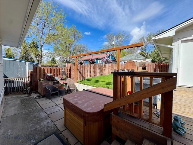 205 E Chinook St, Livingston, MT 59047 - deck featuring a fenced backyard, a storage unit, a patio, a hot tub, and an outdoor structure