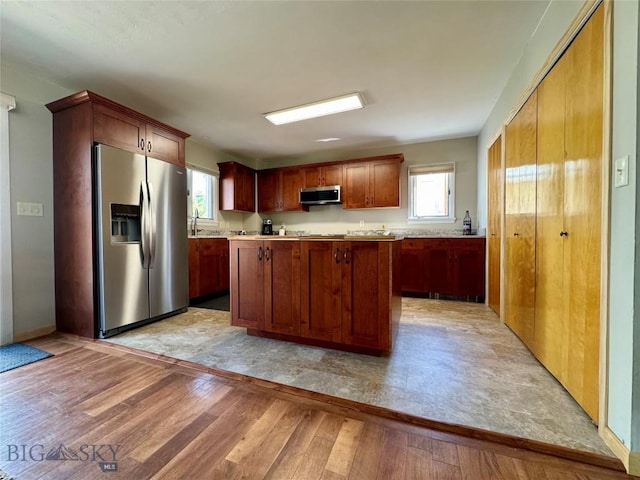 205 E Chinook St, Livingston, MT 59047 - kitchen with stainless steel appliances, light wood finished floors, light countertops, and plenty of natural light