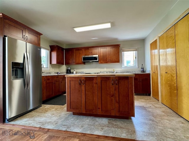 205 E Chinook St, Livingston, MT 59047 - kitchen featuring appliances with stainless steel finishes, a kitchen island, and light countertops