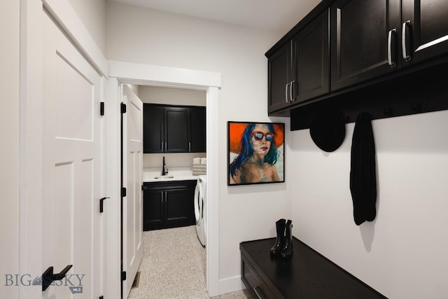 1210 Cody Dr, Belgrade, MT 59714 - hallway featuring washer and clothes dryer, baseboards, and a sink