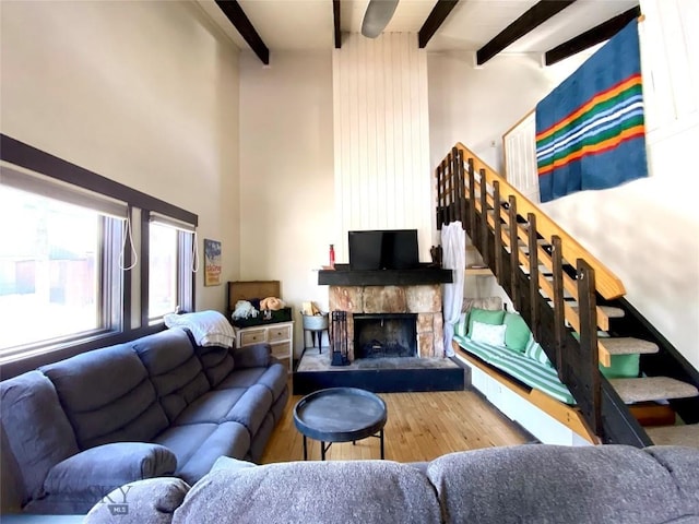 2575 Curley Bear Rd Unit 141, Big Sky, MT 59716 - living room with beam ceiling, wood finished floors, a towering ceiling, and a stone fireplace