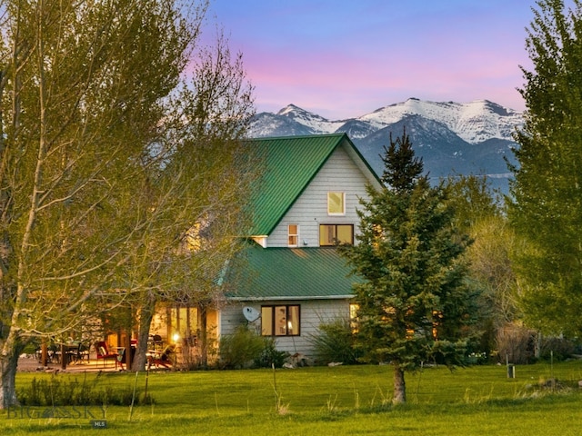 530 W Hulbert Rd, Bozeman, MT 59718 - property exterior at dusk with a lawn, a mountain view, and metal roof