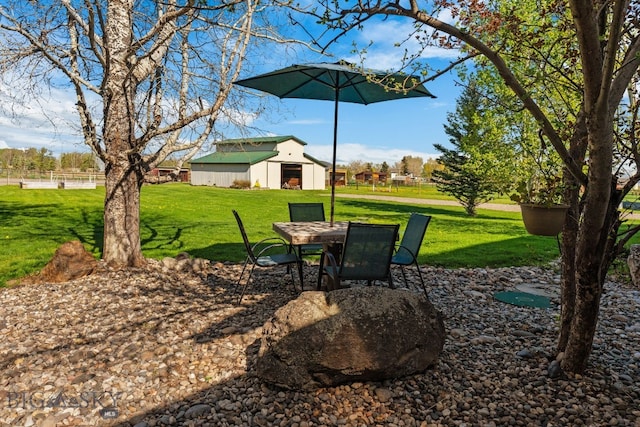 530 W Hulbert Rd, Bozeman, MT 59718 - view of grassy yard with an outbuilding and a pole building