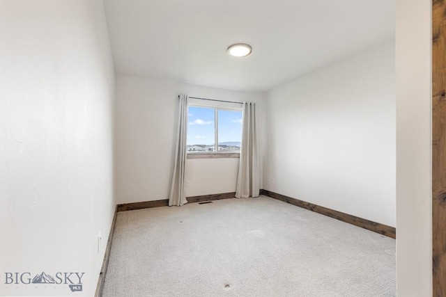 empty room with light carpet and baseboards