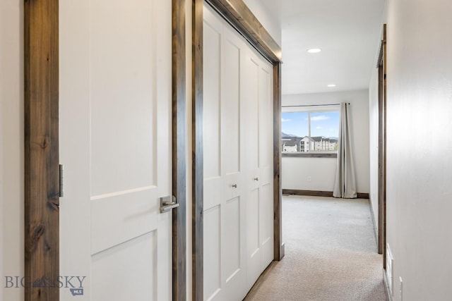corridor featuring light carpet, recessed lighting, and baseboards