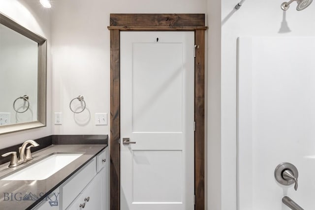 full bathroom with vanity and a shower