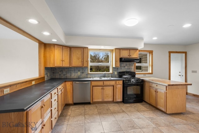 601 N C St, Livingston, MT 59047 - kitchen with stainless steel dishwasher, black gas stove, a peninsula, a sink, and under cabinet range hood