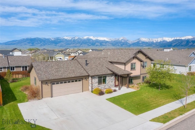 1510 Ingomar Blvd, Belgrade, MT 59714 - view of front of property featuring a residential view, a mountain view, a garage, and a front yard