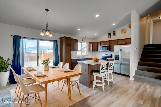 1510 Ingomar Blvd, Belgrade, MT 59714 - dining space with stairway, light wood-type flooring, a chandelier, lofted ceiling, and recessed lighting
