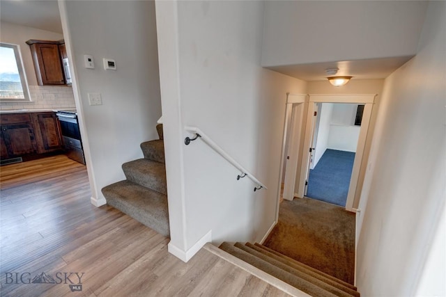 1510 Ingomar Blvd, Belgrade, MT 59714 - stairway featuring wood finished floors and baseboards