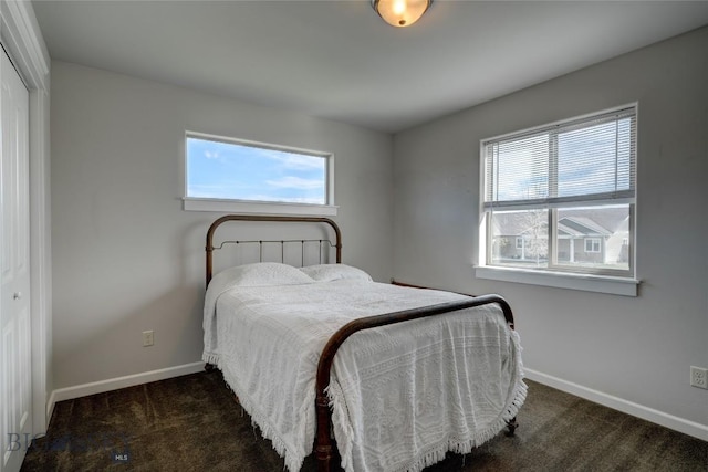 1510 Ingomar Blvd, Belgrade, MT 59714 - carpeted bedroom with baseboards, multiple windows, and a closet