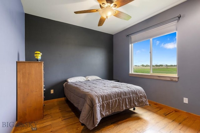 680 Countryside Ln, Belgrade, MT 59714 - bedroom with wood finished floors, baseboards, and a ceiling fan