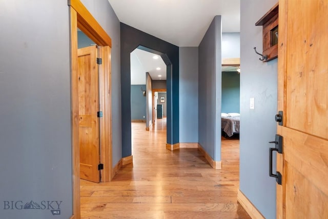 680 Countryside Ln, Belgrade, MT 59714 - hall featuring light wood finished floors, arched walkways, and baseboards