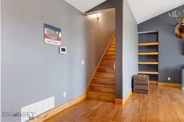 680 Countryside Ln, Belgrade, MT 59714 - stairs featuring vaulted ceiling, wood-type flooring, and baseboards