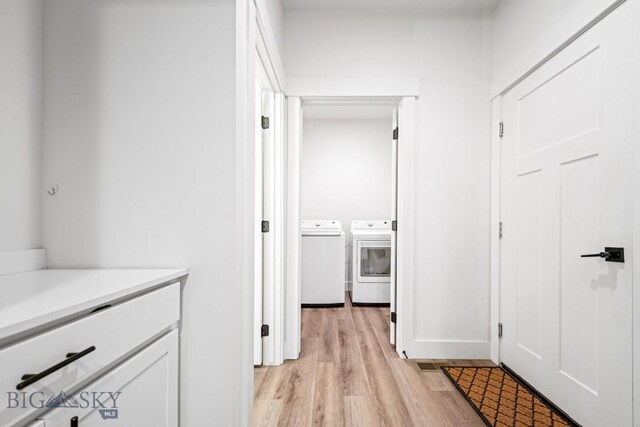 1506 Wild Bill Way, Belgrade, MT 59714 - hall featuring washing machine and dryer, light wood-type flooring, and baseboards