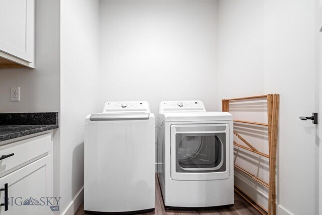 1506 Wild Bill Way, Belgrade, MT 59714 - clothes washing area with independent washer and dryer, cabinet space, dark wood-type flooring, and baseboards